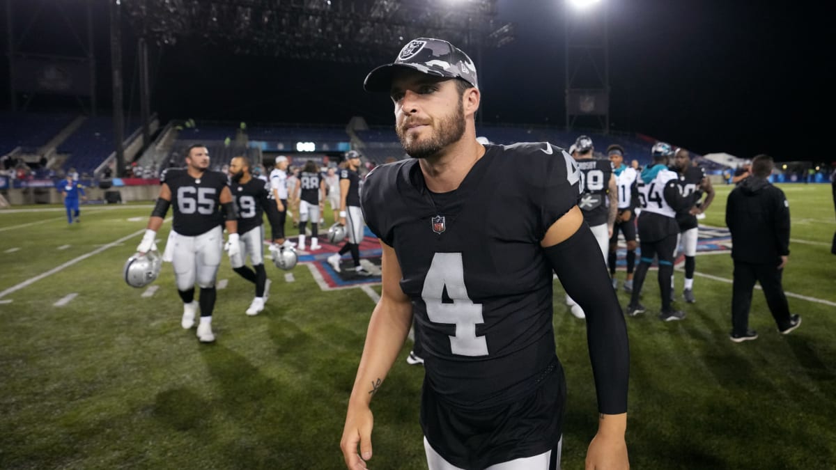 A young Raiders fan holds up a Derek Carr jersey before an NFL football  game against the Kansas …