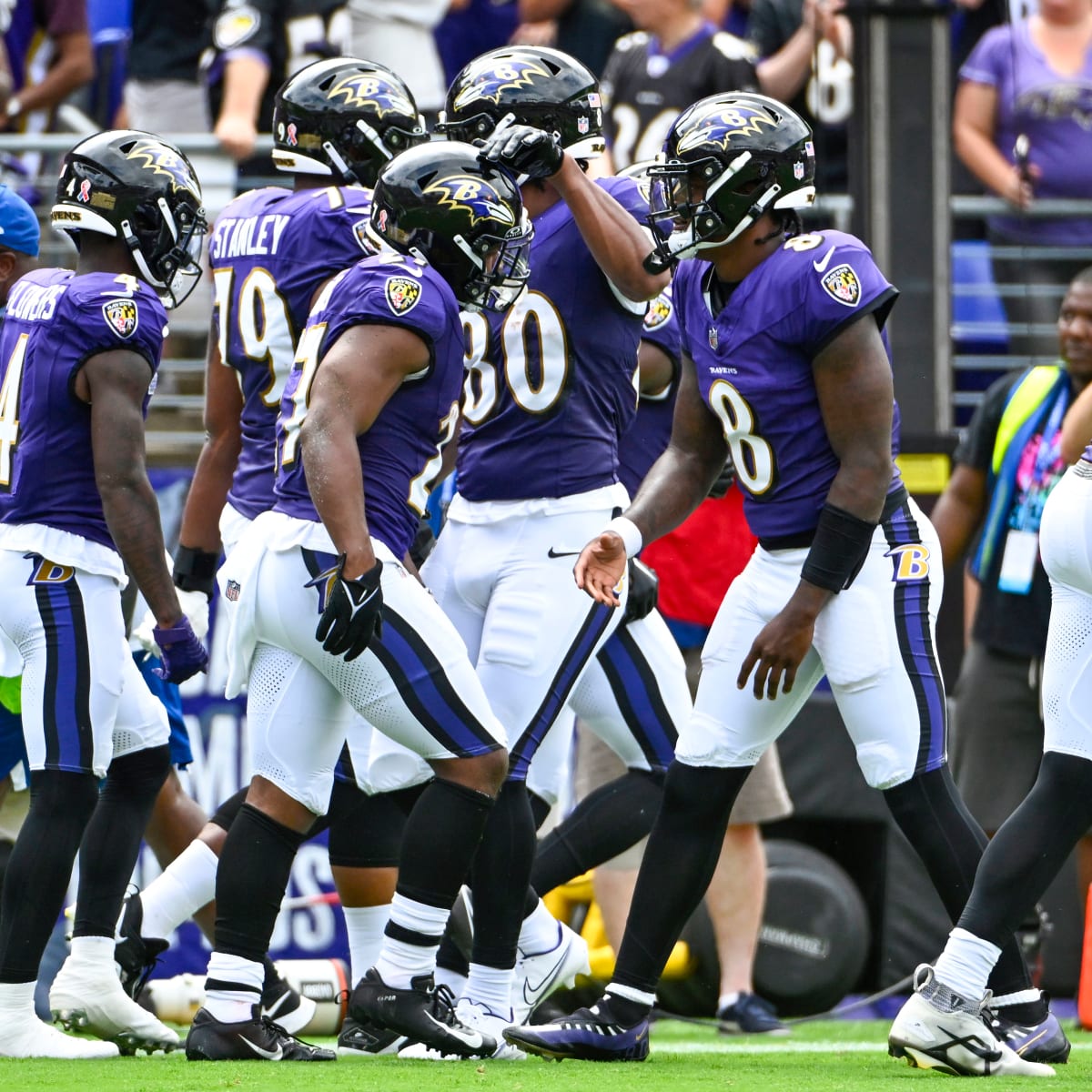 Baltimore Ravens running back J.K. Dobbins (27) takes a handoff from  quarterback Lamar Jackson …