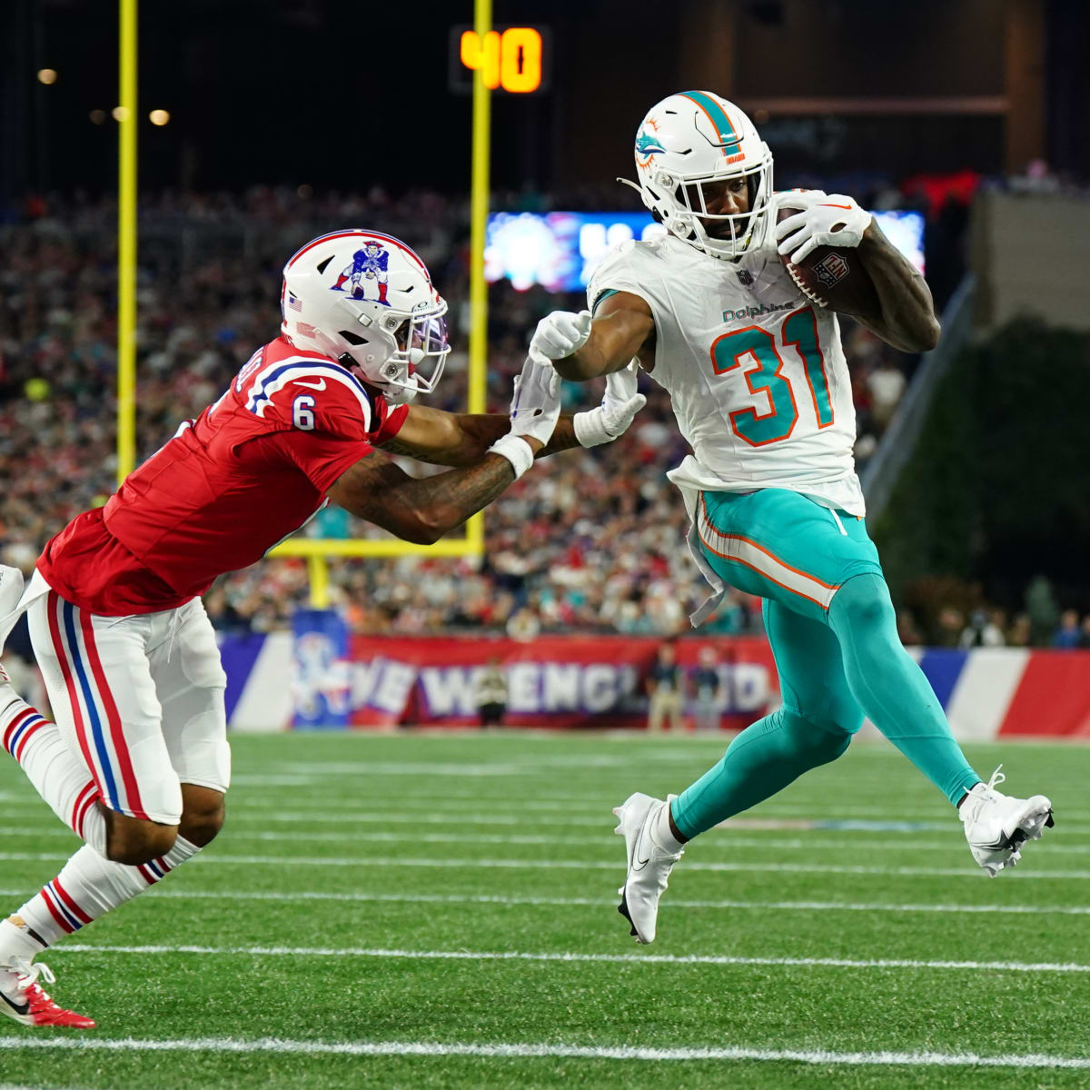 Miami Dolphins running back Raheem Mostert (31) celebrates with teammates  after scoring a touchdown against the Denver Broncos during the second  quarter of an NFL football game at Hard Rock Stadium, Sunday