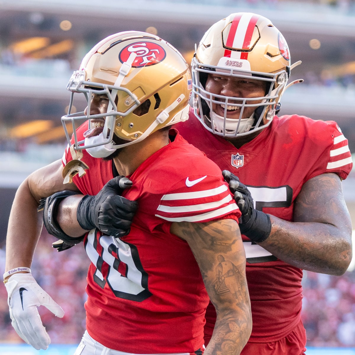 San Francisco 49ers quarterback Brock Purdy (13) gives the football to  guard Aaron Banks (65) to