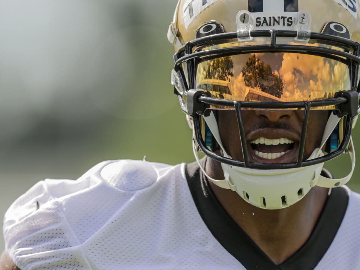 New Orleans Saints wide receiver Chris Olave wears his helmet