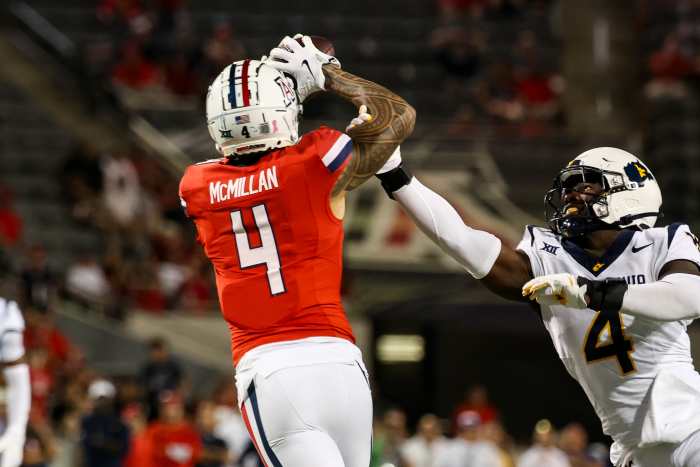 Oct 26, 2024; Tucson, Arizona, USA; Arizona Wildcats wide receiver Tetairoa McMillan (4) catches a long pass while West Virginia Mountaineers linebacker Trey Lathan (4) fails to defend against him during the fourth quarter at Arizona Stadium.