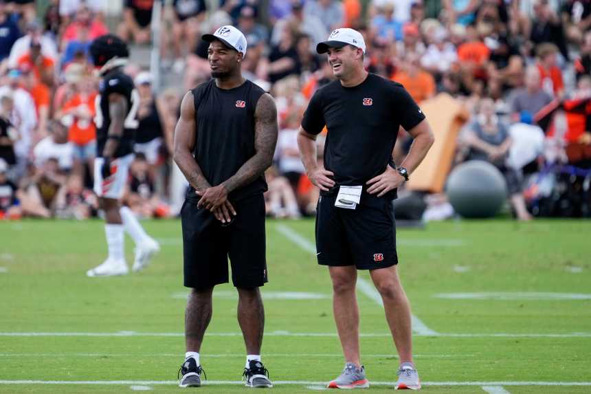 Cincinnati Bengals wide receiver Ja'Marr Chase (1) talks with head coach Zac Taylor on the sideline during a preseason training camp practice at the Paycor Stadium practice field in downtown Cincinnati on Wednesday, Aug. 7, 2024.