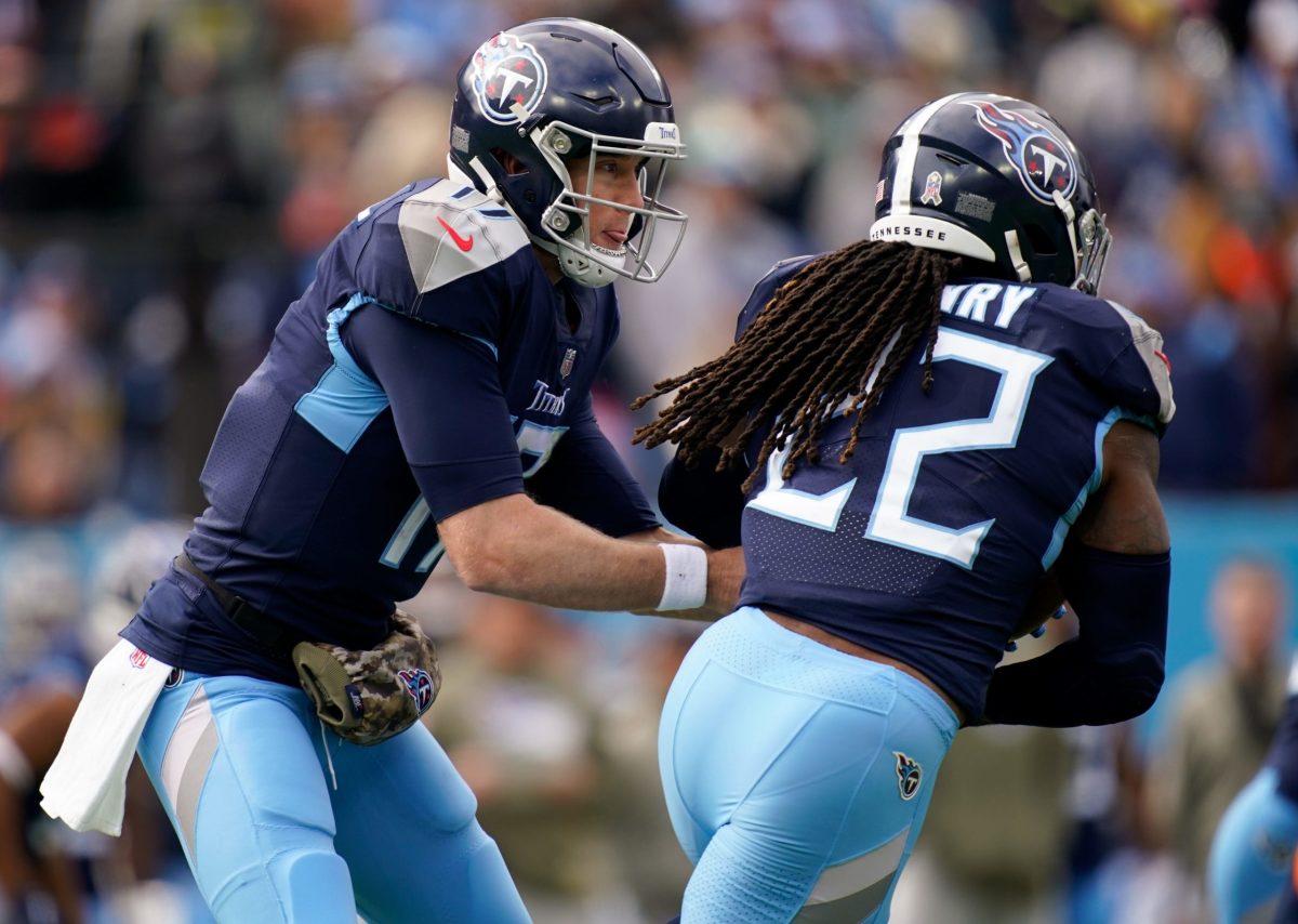 Tennessee Titans quarterback Ryan Tannehill (17) hands off to Trunning back  Derrick Henry (22) during the first half of an NFL Divisional Playoff game  at Nissan Stadium in Nashville, Tennessee, on Saturday