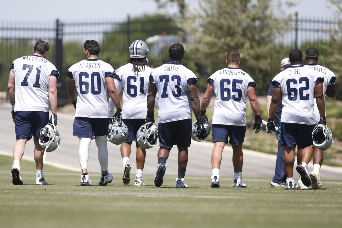 ARLINGTON, TX - DECEMBER 04: Dallas Cowboys offensive tackle Tyler Smith (73)  runs off the field