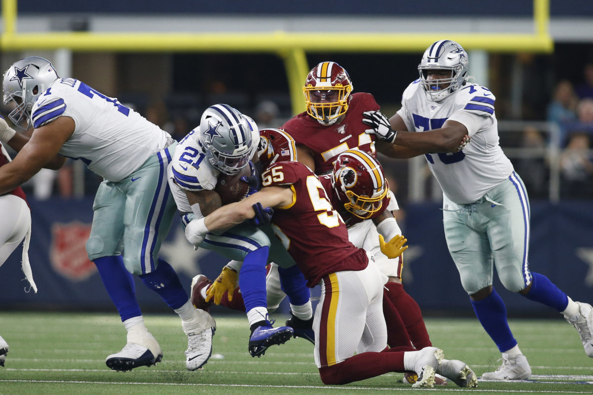 Cowboys defense tackling Washington player during game