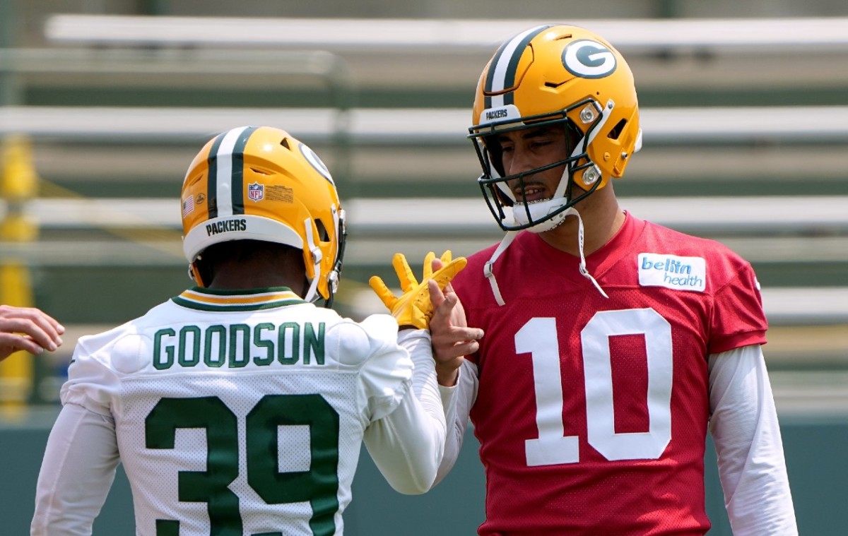 Bulldogs In The NFL - Image 1: Green Bay Packers quarterback Aaron Rodgers  (12) holds the football out while trying to gain a first down as Chicago  Bears inside linebacker Danny Trevathan (