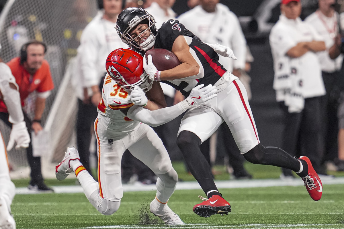 Falcons wide receiver Drake London is hit by Chiefs cornerback Jaylen Watson.