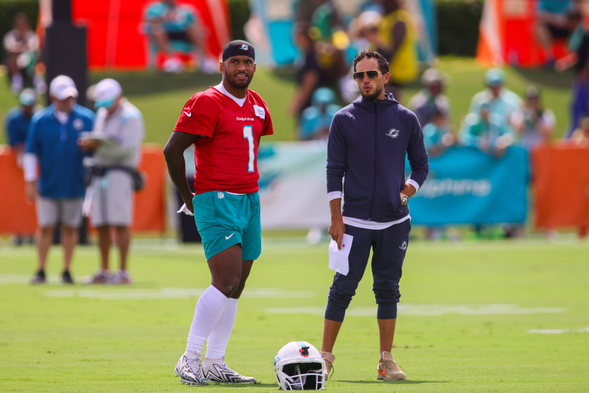 Miami Dolphins quarterback Tua Tagovailoa (1) talks to head coach Mike McDaniel during training camp at Baptist Health Training Complex