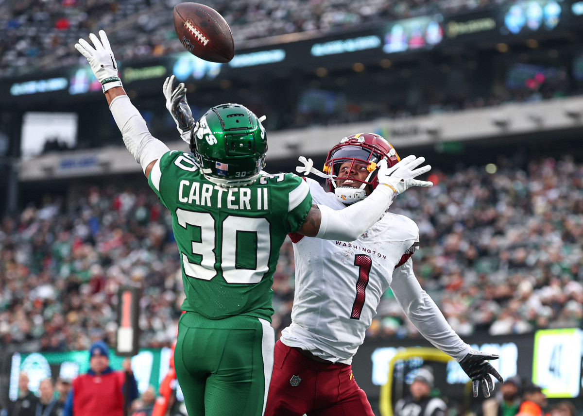 New York Jets cornerback Michael Carter II (30) breaks up a pass intended for Washington Commanders wide receiver Jahan Dotson (1) during the second half at MetLife Stadium.