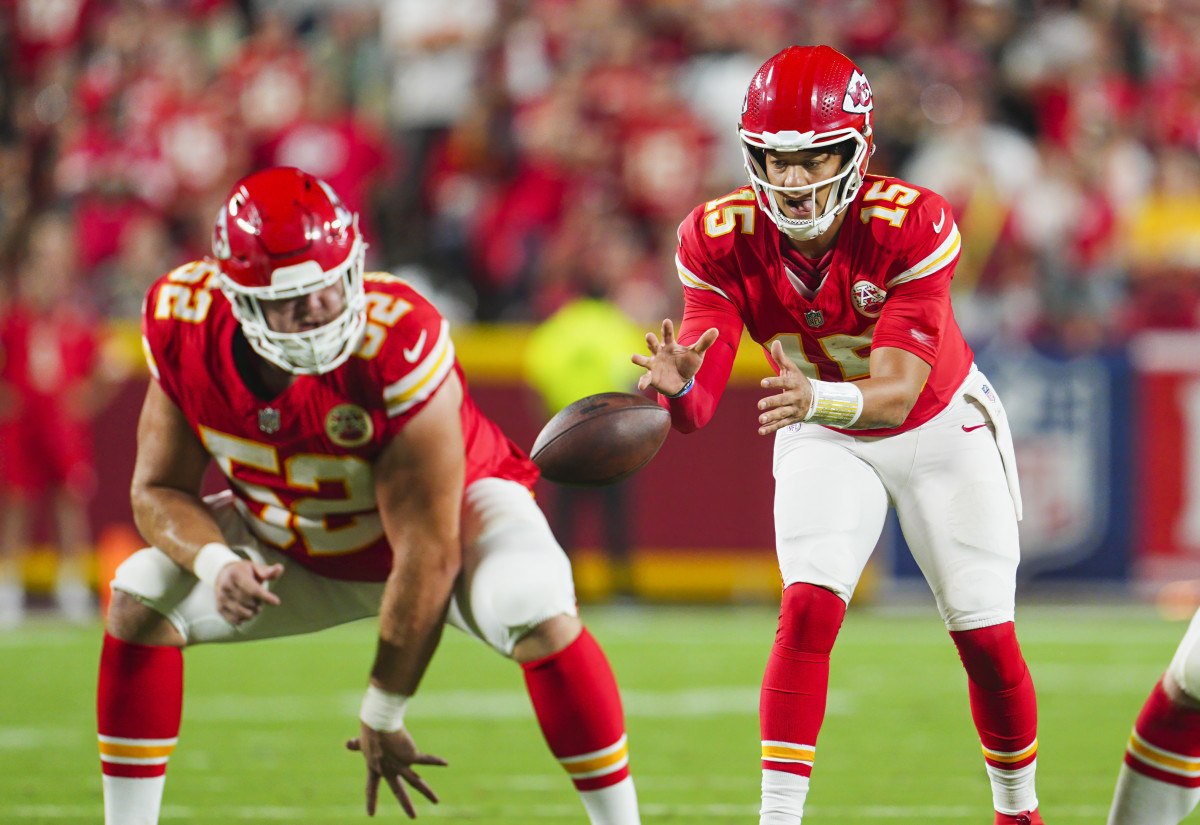 Chiefs quarterback Patrick Mahomes (15) takes the snap from center Creed Humphrey (52) during the second half against the Ravens