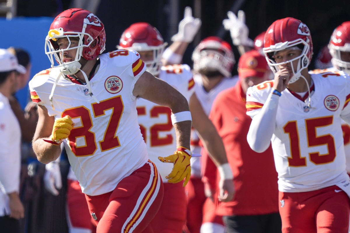 Nov 24, 2024; Charlotte, North Carolina, USA; Kansas City Chiefs tight end Travis Kelce (87) and quarterback Patrick Mahomes (15) lead their team onto the field against the Carolina Panthers during the first quarter at Bank of America Stadium.
