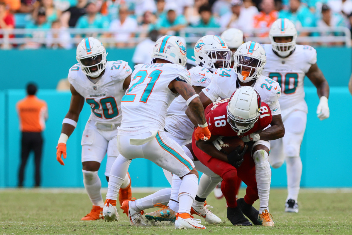 Oct 27, 2024; Miami Gardens, Florida, USA; Arizona Cardinals wide receiver Marvin Harrison Jr. (18) runs with the football against Miami Dolphins cornerback Cam Smith (24) during the fourth quarter at Hard Rock Stadium.