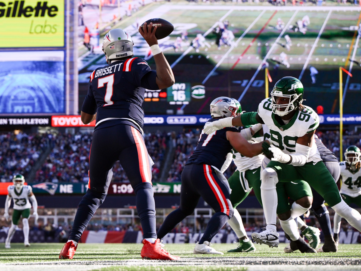 Oct 27, 2024; Foxborough, Massachusetts, USA; New England Patriots quarterback Jacoby Brissett (7) passes under pressure from New York Jets defensive end Will McDonald IV (99) during the second half at Gillette Stadium.