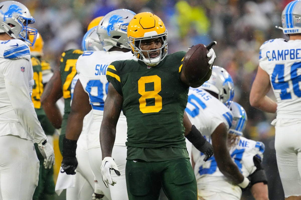 Green Bay Packers running back Josh Jacobs (8) gestures after earning a first down during the first quarter against the Detroit Lions at Lambeau Field. 