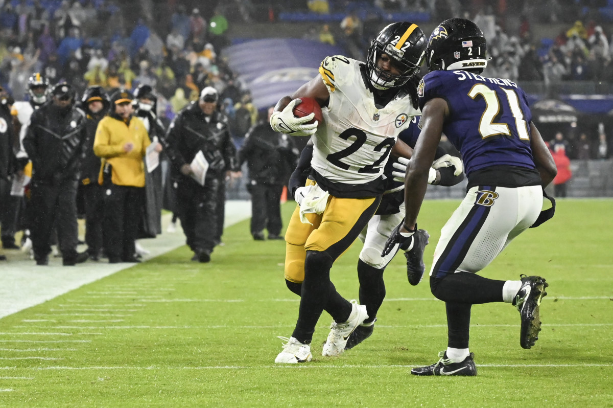 Steelers running back Najee Harris rushes as Baltimore Ravens cornerback Brandon Stephens defends.