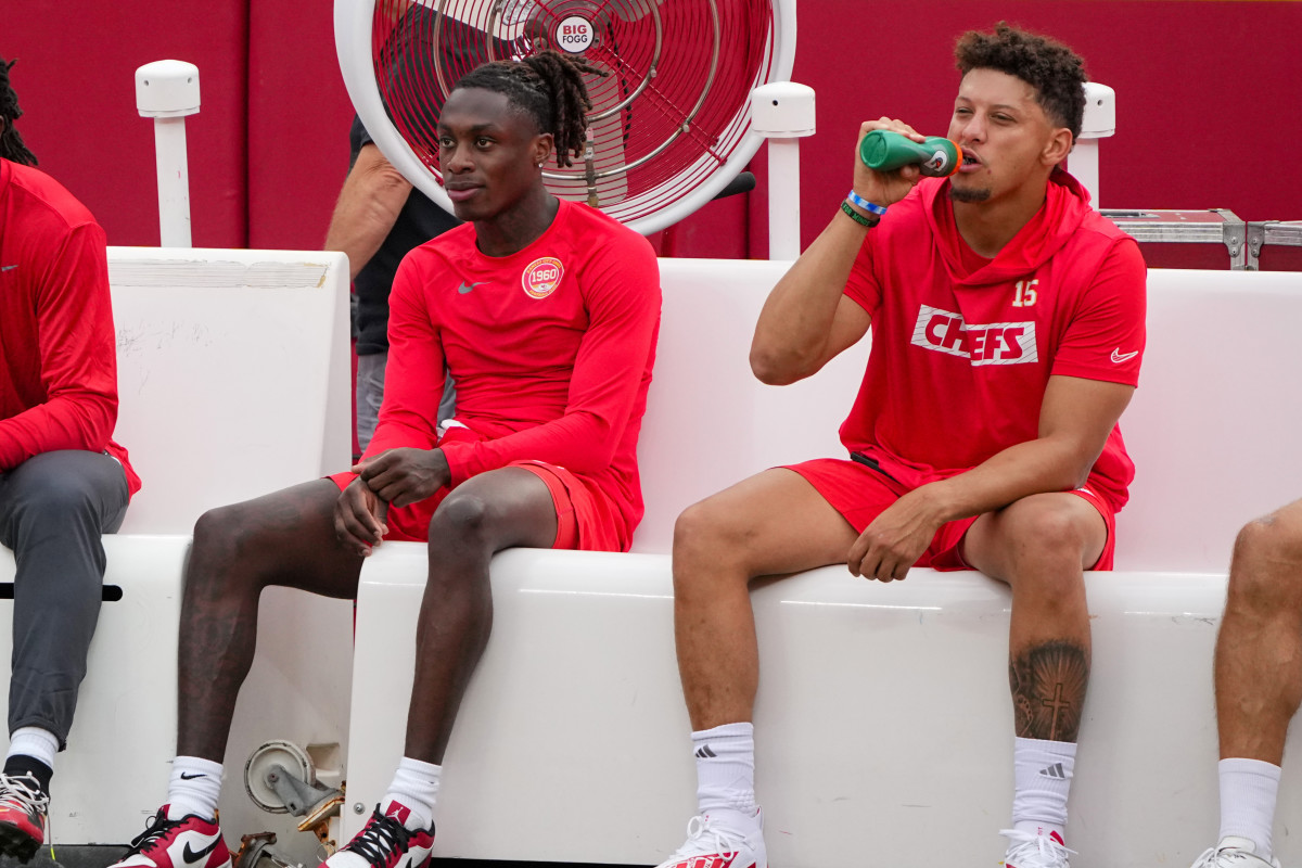 Aug 22, 2024; Kansas City, Missouri, USA; Kansas City Chiefs wide receiver Xavier Worthy (1) and quarterback Patrick Mahomes (15) sit on their bench during warm ups against the Chicago Bears prior to a game at GEHA Field at Arrowhead Stadium.