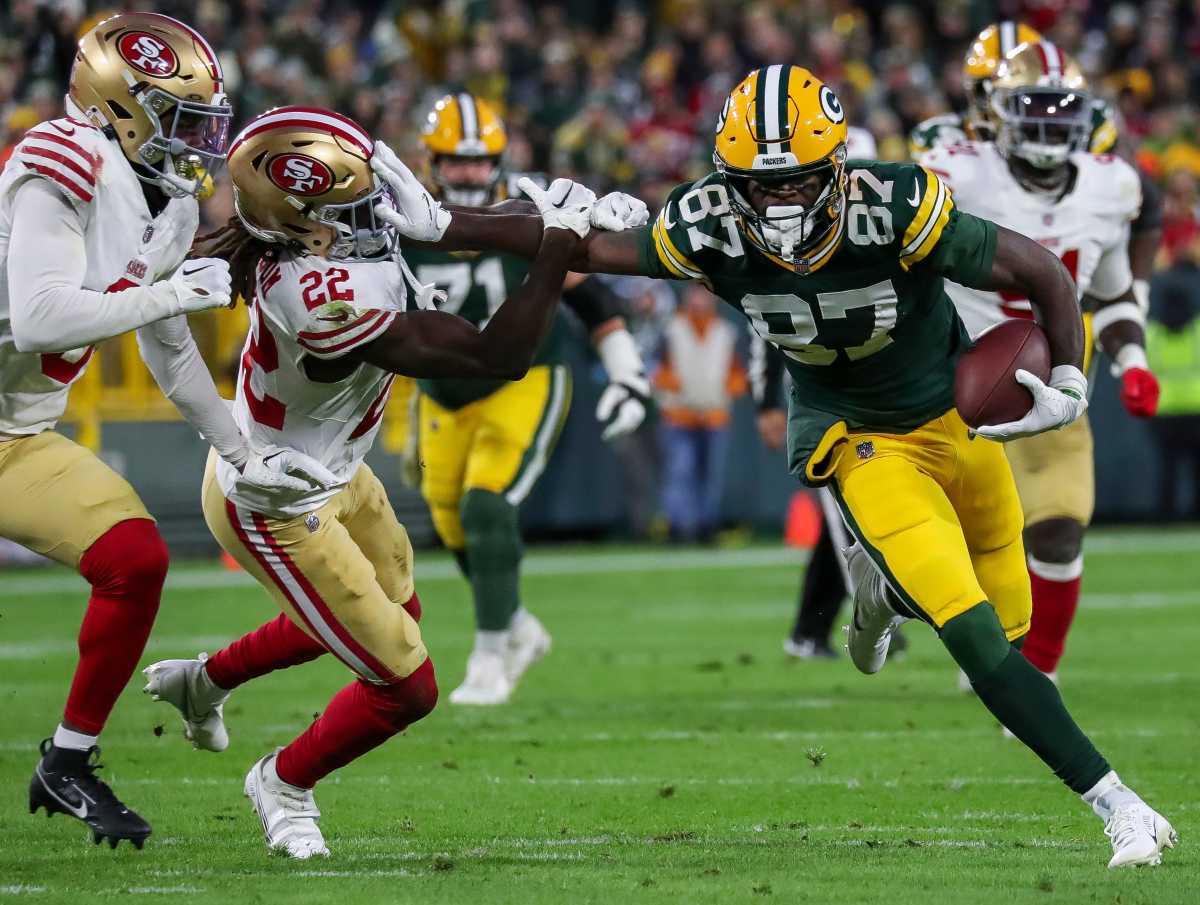 Green Bay Packers wide receiver Romeo Doubs (87) stiff-arms San Francisco 49ers cornerback Isaac Yiadom (22) as he runs after making a catch on Sunday, November 24, 2024, at Lambeau Field in Green Bay, Wis. The Packers won the game, 38-10.