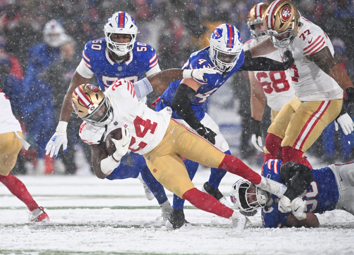 San Francisco 49ers running back Jordan Mason (24) is tackled by Buffalo Bills linebacker Nicholas Morrow (32) in the second quarter at Highmark Stadium.