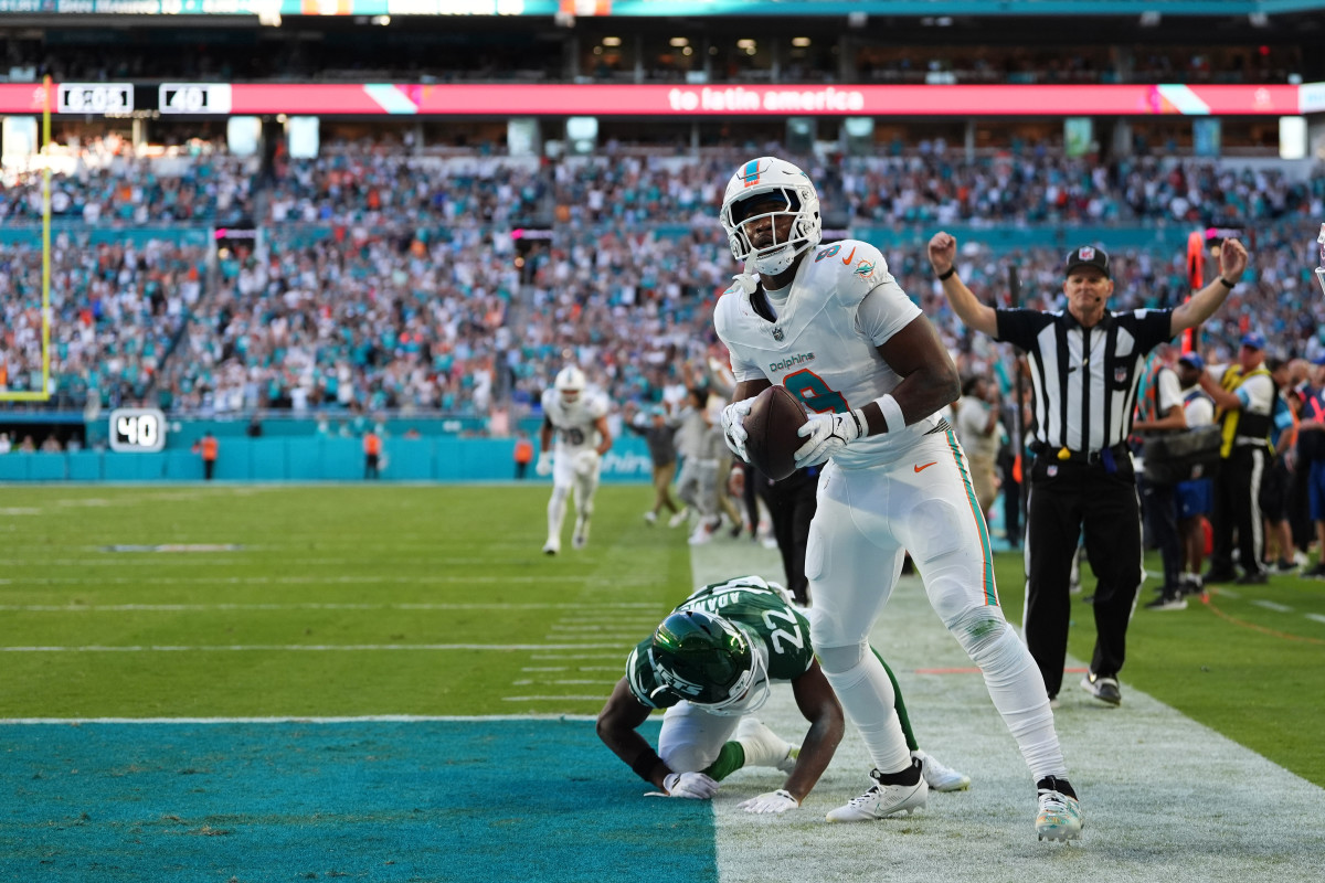 Dec 8, 2024; Miami Gardens, Florida, USA; Miami Dolphins tight end Jonnu Smith (9) celebrates his game winning touchdown against the New York Jets during overtime at Hard Rock Stadium.