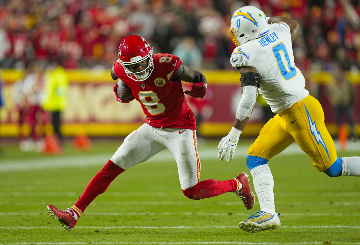 Dec 8, 2024; Kansas City, Missouri, USA; Kansas City Chiefs wide receiver DeAndre Hopkins (8) runs with the ball against Los Angeles Chargers linebacker Daiyan Henley (0) during the first half at GEHA Field at Arrowhead Stadium.