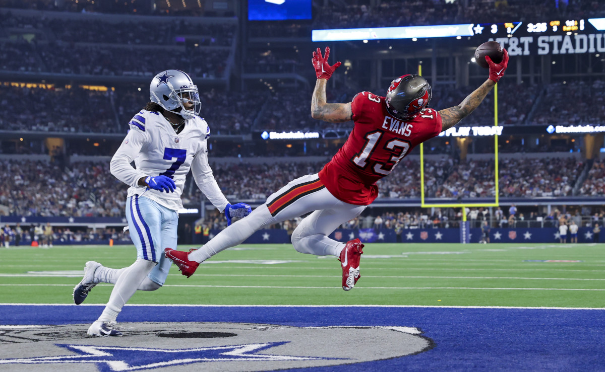 Sep 11, 2022; Arlington, Texas, USA; Tampa Bay Buccaneers wide receiver Mike Evans (13) makes a leaping touchdown catch over Dallas Cowboys cornerback Trevon Diggs (7) during the third quarter at AT&T Stadium.