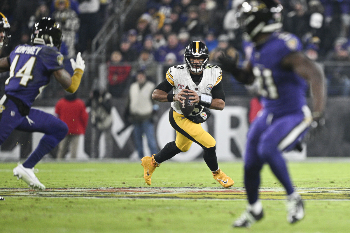 Dec 21, 2024; Baltimore, Maryland, USA; Pittsburgh Steelers quarterback Russell Wilson (3) rolls pout top pass durn the first half against the Baltimore Ravens at M&T Bank Stadium.