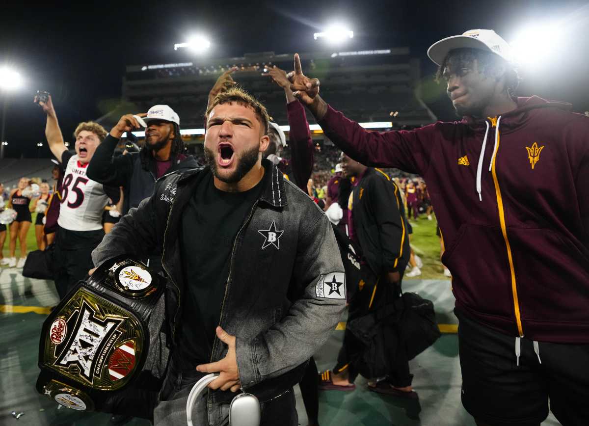 ASU running back Cam Skattebo arrives to the sidelines wearing the Big 12 championship belt around his arm after the team won the Big 12 title earlier in the day against Iowa State on Dec. 7, 2024. The team was greeted by fans of the Open State Championship. 