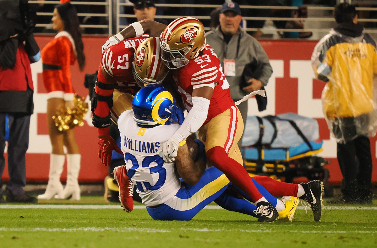 San Francisco 49ers linebacker Dre Greenlaw (57) and linebacker Dee Winters (53) bring down Los Angeles Rams running back Kyren Williams (23) during the first quarter at Levi's Stadium.