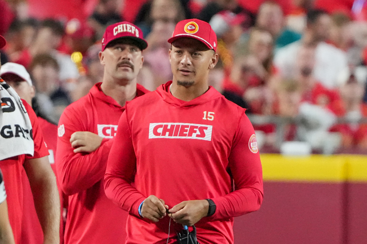 Aug 22, 2024; Kansas City, Missouri, USA; Kansas City Chiefs tight end Travis Kelce (87) and quarterback Patrick Mahomes (15) react to play on the sidelines against the Chicago Bears during the game at GEHA Field at Arrowhead Stadium.