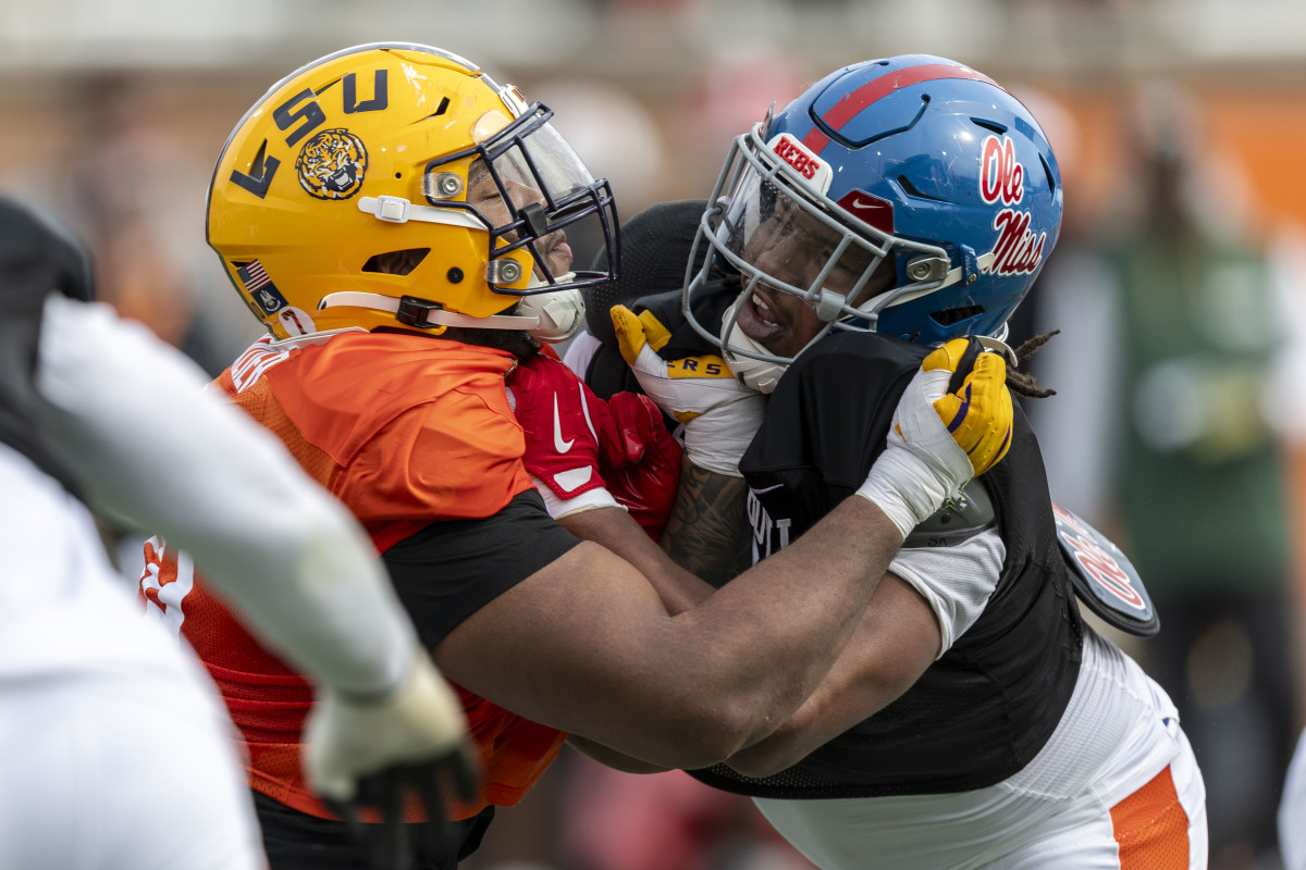 American team offensive lineman Miles Frazier of LSU (70) spars with American team defensive lineman Walter Nolen of Ole Miss (2) during Senior Bowl practice for the American team at Hancock Whitney Stadium. 