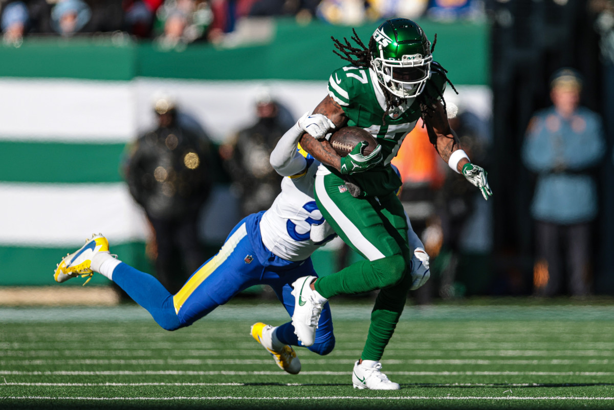 New York Jets wide receiver Davante Adams (17) fights for yards as Los Angeles Rams safety Quentin Lake (37) tackles during the first half at MetLife Stadium. 