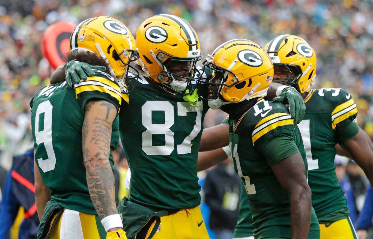 Green Bay Packers wide receiver Romeo Doubs (87) celebrates scoring a touchdown with wide receiver Christian Watson (9), wide receiver Jayden Reed (11) and running back Emanuel Wilson (31) against the Arizona Cardinals during their football game Sunday, October 13, 2024, at Lambeau Field in Green Bay, Wisconsin.