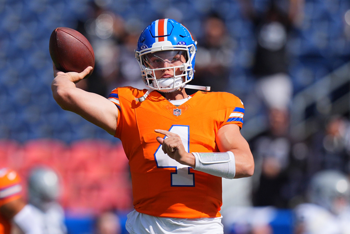 Denver Broncos quarterback Zach Wilson (4) warms up before the game against the Las Vegas Raiders at Empower Field at Mile High.
