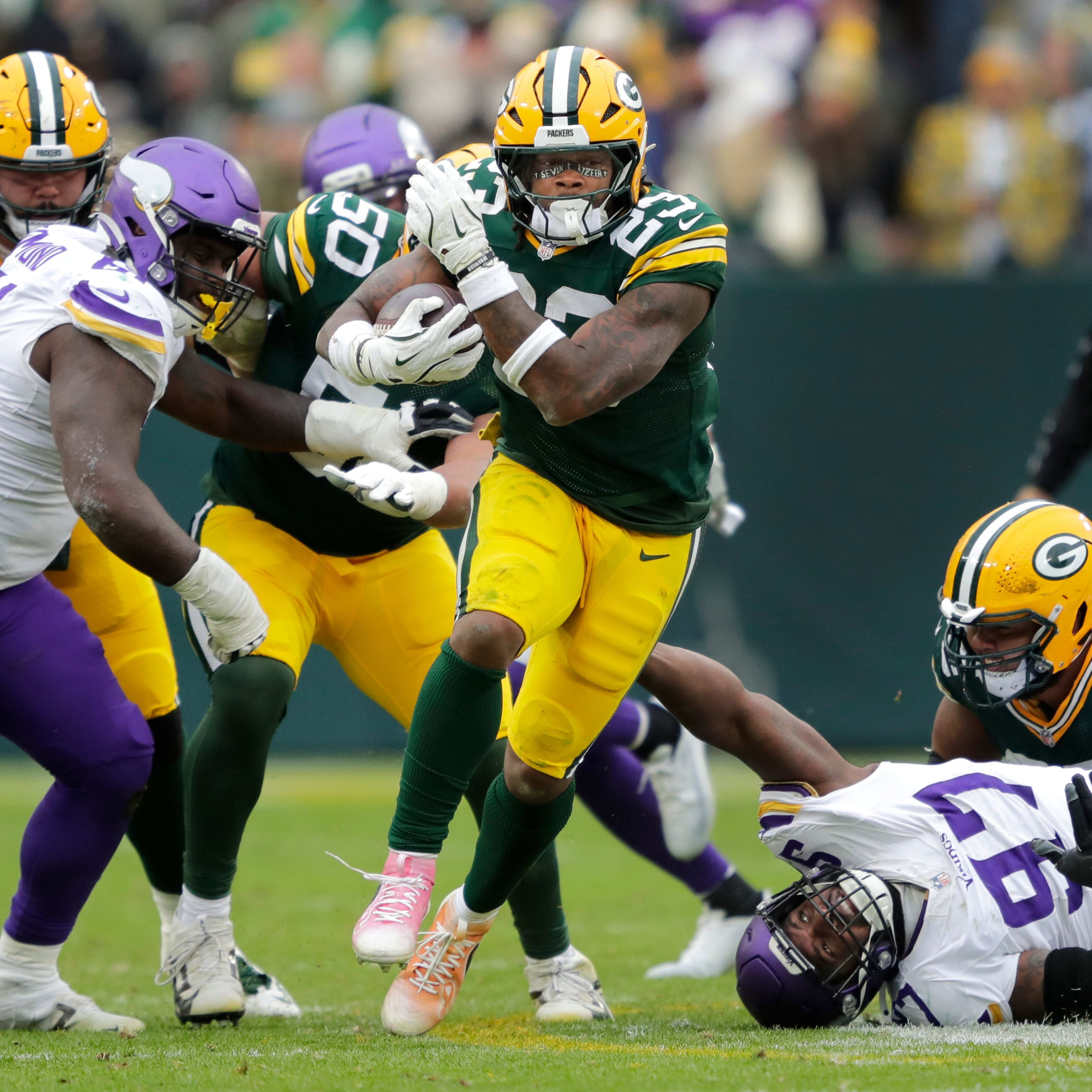 Green Bay Packers running back Emanuel Wilson (23) runs for a first down against the Minnesota Vikings in the third quarter during their football game Sunday, November 23, 2025, at Lambeau Field in Green Bay, Wisconsin.