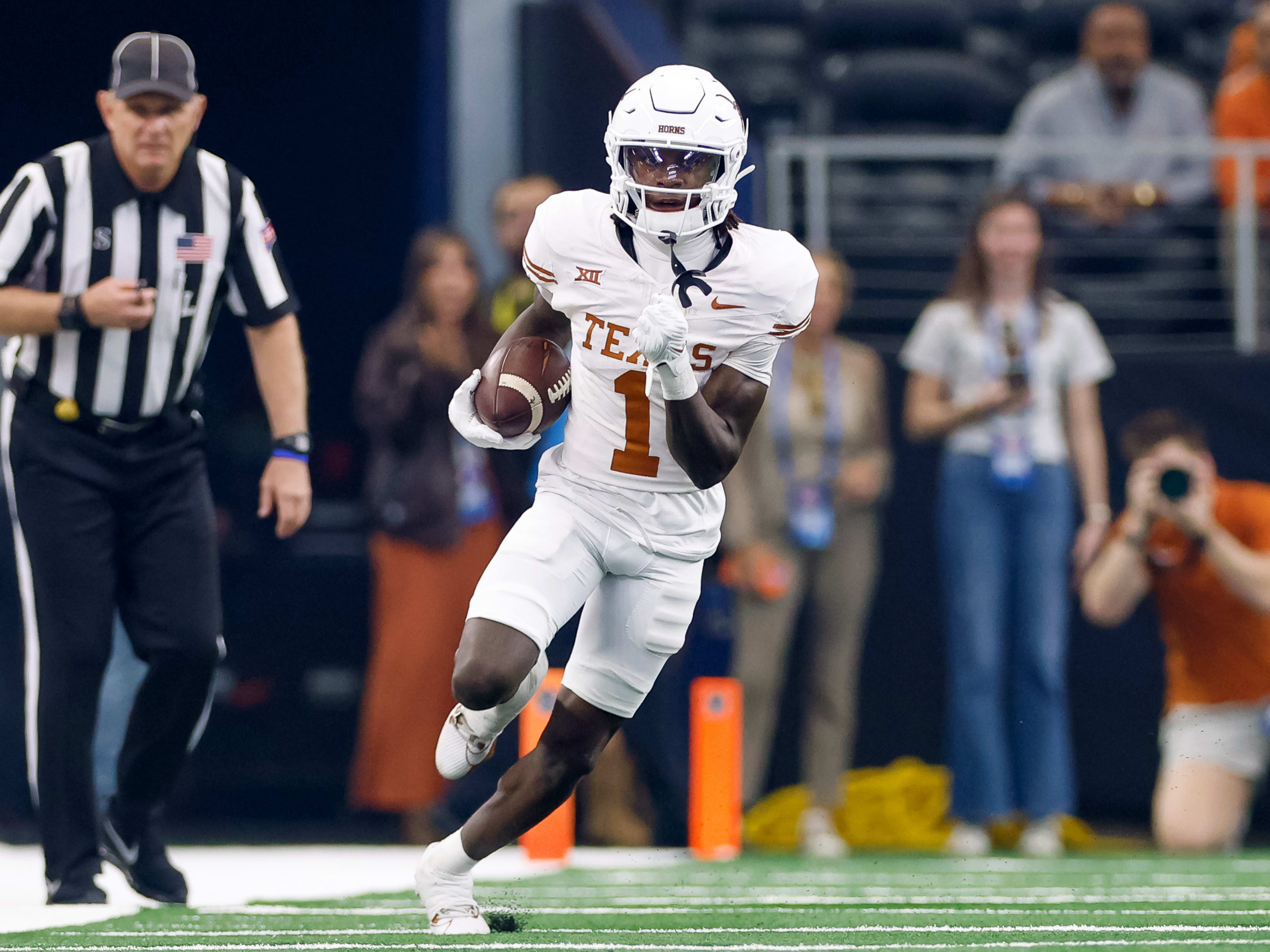 Dec 2, 2023; Arlington, TX, USA; Texas Longhorns wide receiver Xavier Worthy (1) runs with the ball during the first quarter against the Oklahoma State Cowboys at AT&T Stadium. Mandatory Credit: Andrew Dieb-USA TODAY Sports
