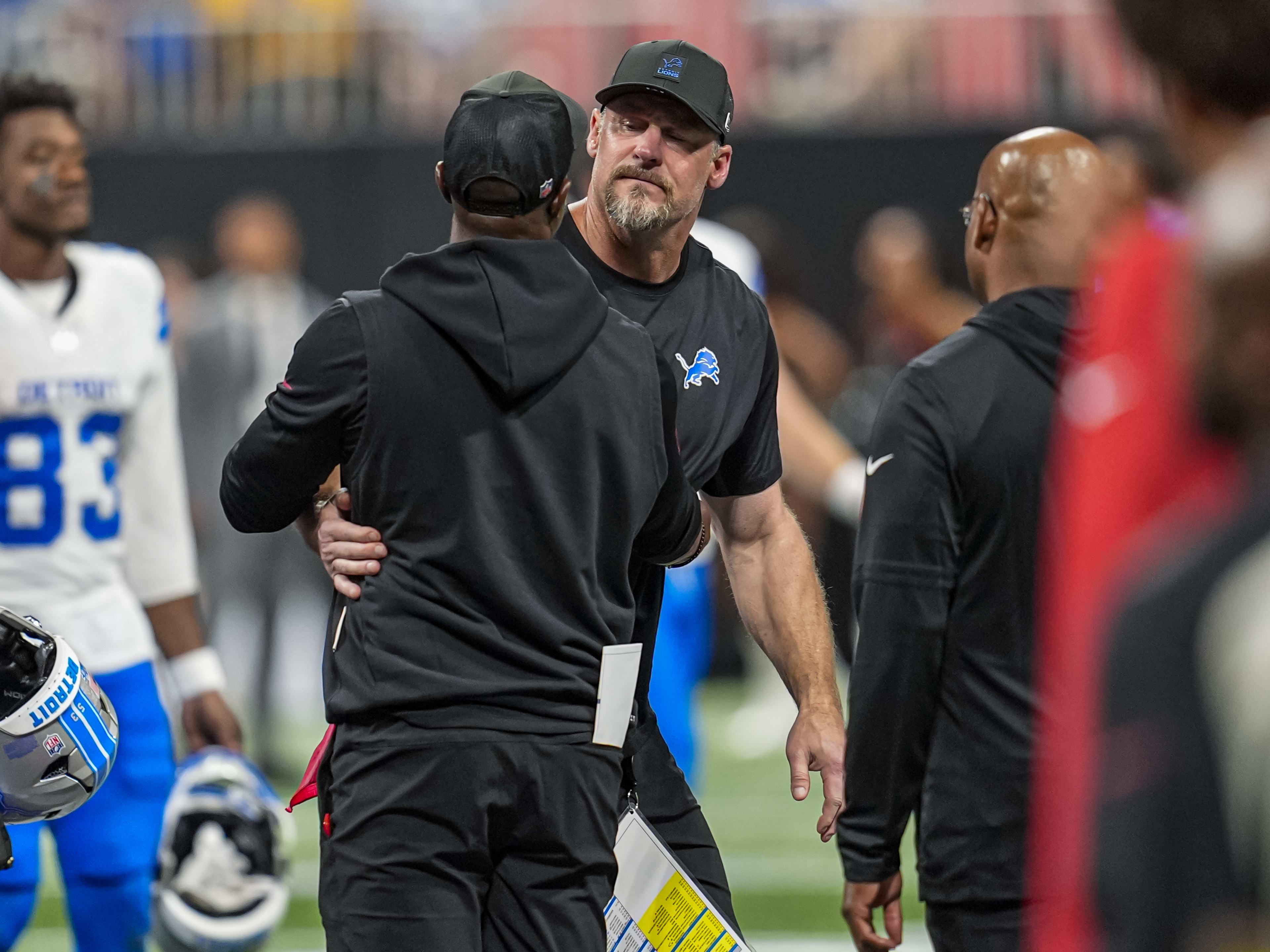 Aug 8, 2025; Atlanta, Georgia, USA; Detroit Lions head coach Dan Campbell and Atlanta Falcons head coach Raheem Morris react after the game was suspended after an injury to Lions safety Morice Norris (26) (not shown) during the game against the Atlanta Falcons at Mercedes-Benz Stadium. Mandatory Credit: Dale Zanine-Imagn Images