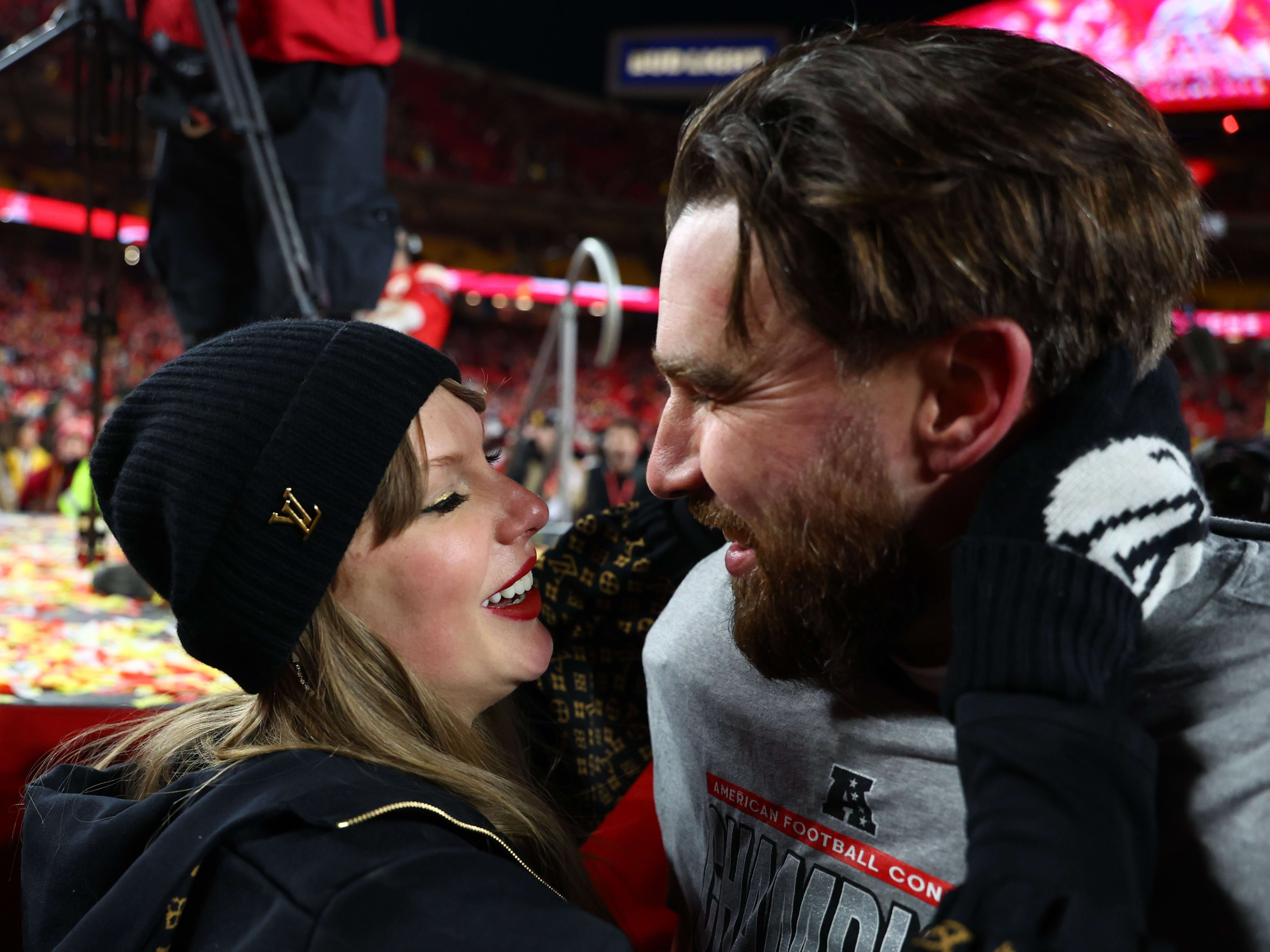 Jan 26, 2025; Kansas City, MO, USA; Recording artist Taylor Swift  and Kansas City Chiefs tight end Travis Kelce (87) react after the AFC Championship game against the Buffalo Bills at GEHA Field at Arrowhead Stadium. Mandatory Credit: Mark J. Rebilas-Imagn Images
