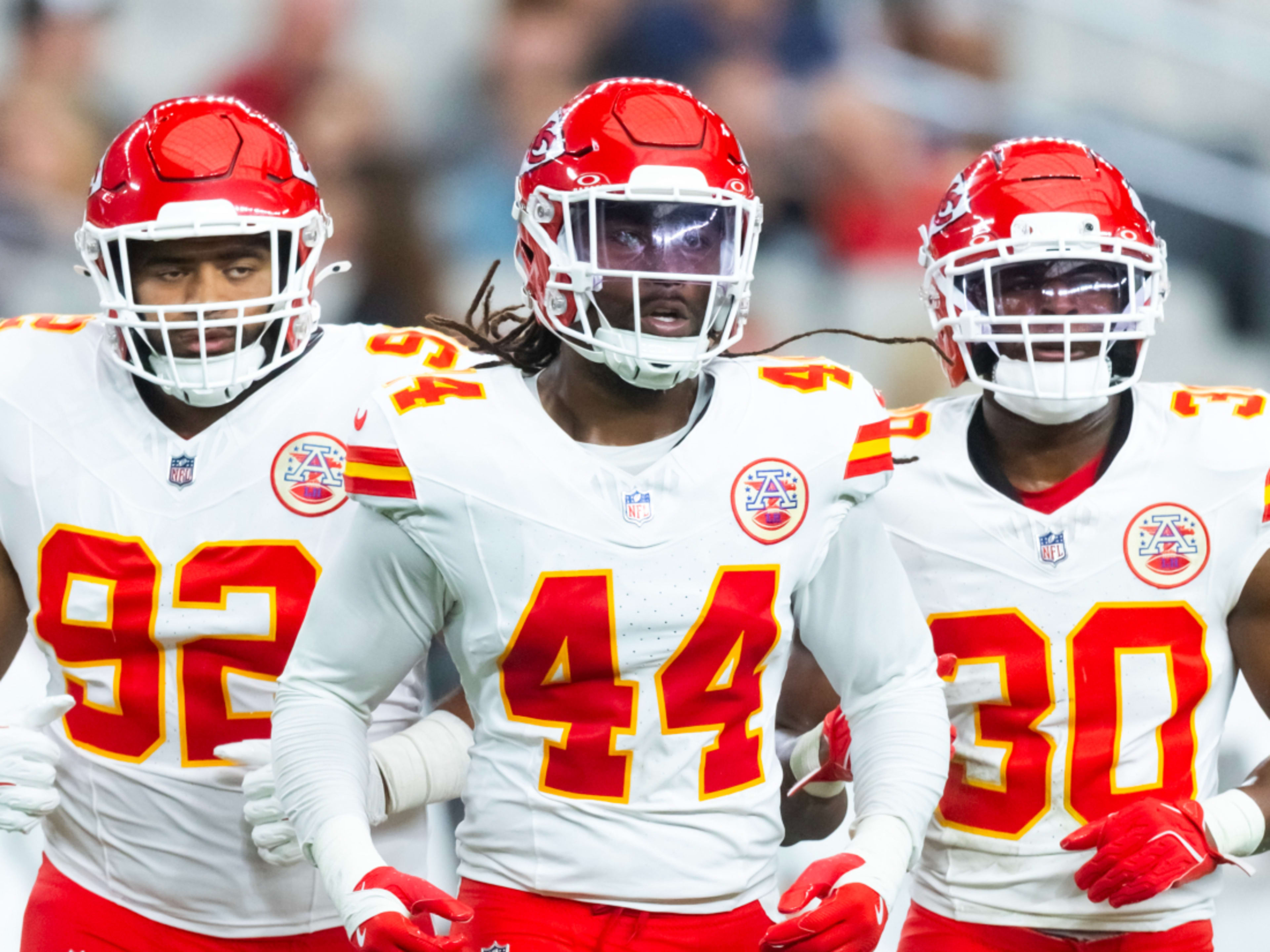 Aug 9, 2025; Glendale, Arizona, USA; Kansas City Chiefs linebacker Cam Jones (44) with defensive tackle Marlon Tuipulotu (92) and safety Chris Roland-Wallace (30) against the Arizona Cardinals during a preseason NFL game at State Farm Stadium. Mandatory Credit: Mark J. Rebilas-Imagn Images 