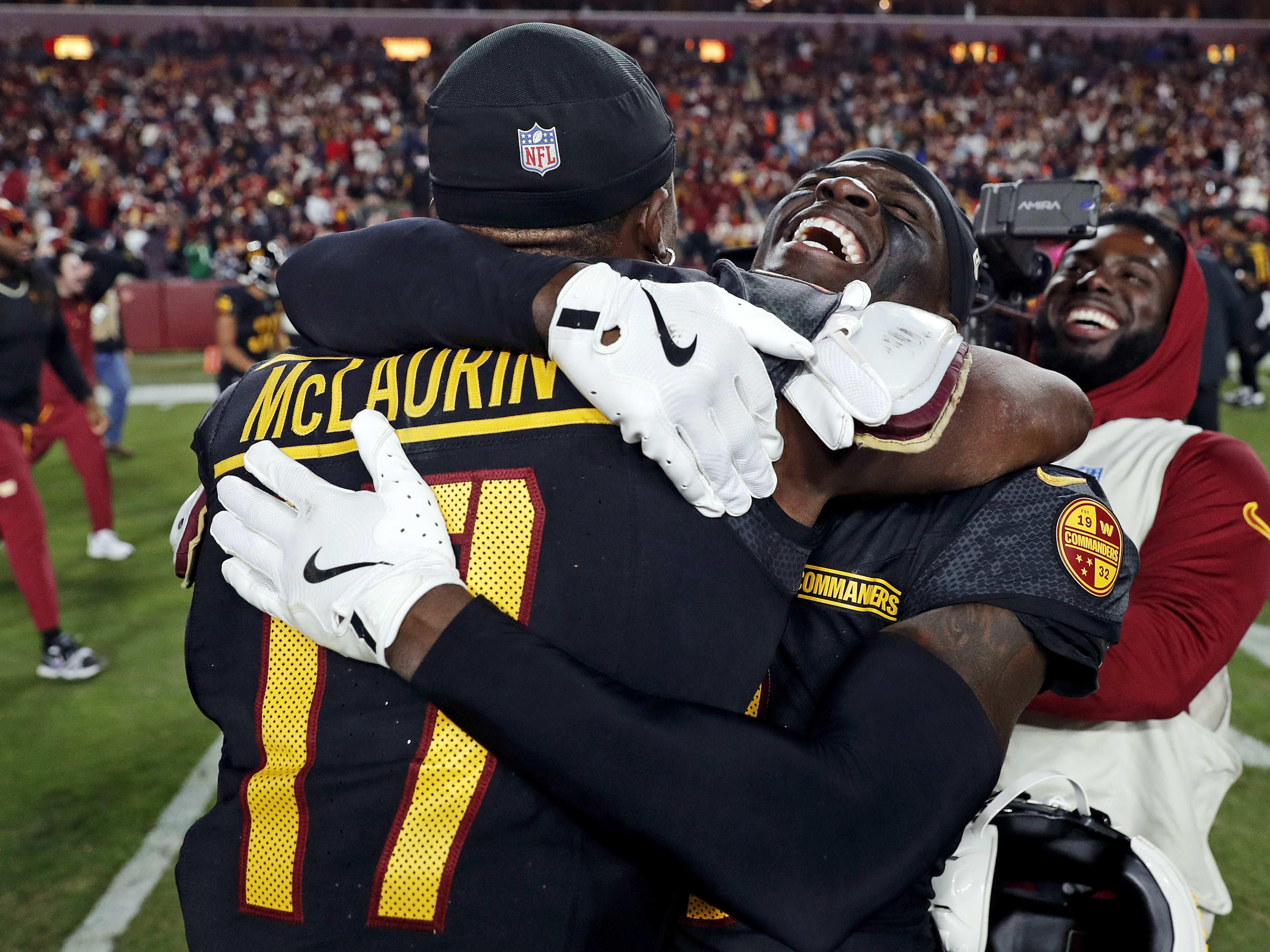 Oct 27, 2024; Landover, Maryland, USA; Washington Commanders wide receiver Terry McLaurin (17) and cornerback Mike Sainristil (0) celebrate after the Washington Commanders beat the Chicago Bears on a Hail Mary pass with no time left at Commanders Field. Mandatory Credit: Peter Casey-Imagn Images
