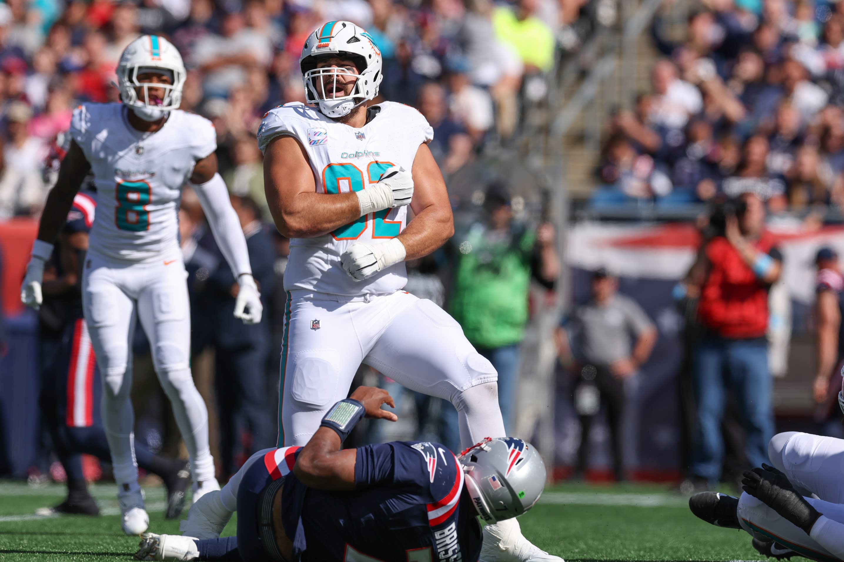 Oct 6, 2024; Foxborough, Massachusetts, USA; Miami Dolphins defensive tackle Zach Sieler (92) celebrates after a sack of New England Patriots quarterback Jacoby Brissett (7) during the first half at Gillette Stadium. 
