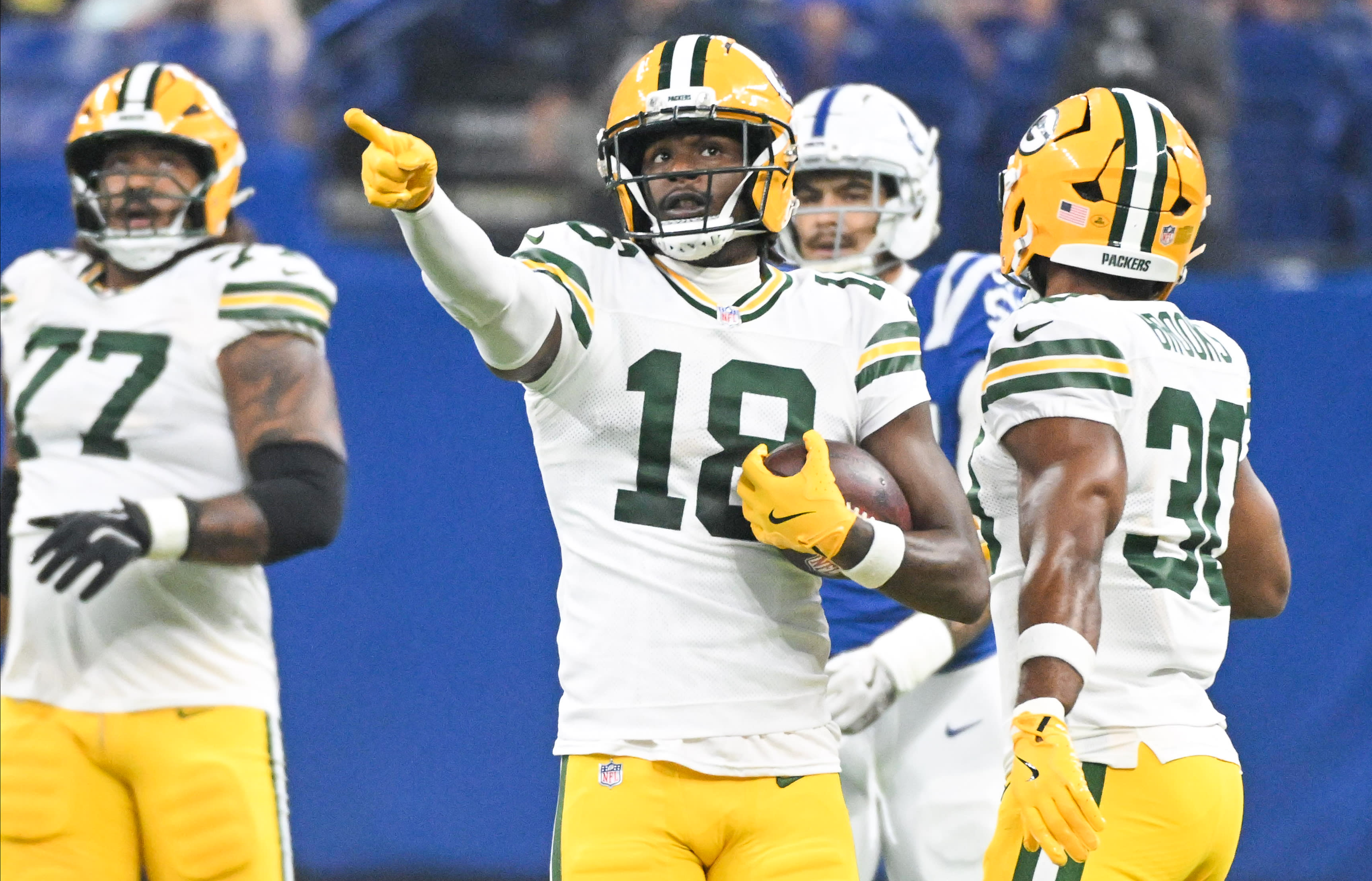 Aug 16, 2025; Indianapolis, Indiana, USA; Green Bay Packers wide receiver Malik Heath (18) celebrates after a first down during the first half against the Indianapolis Colts at Lucas Oil Stadium.