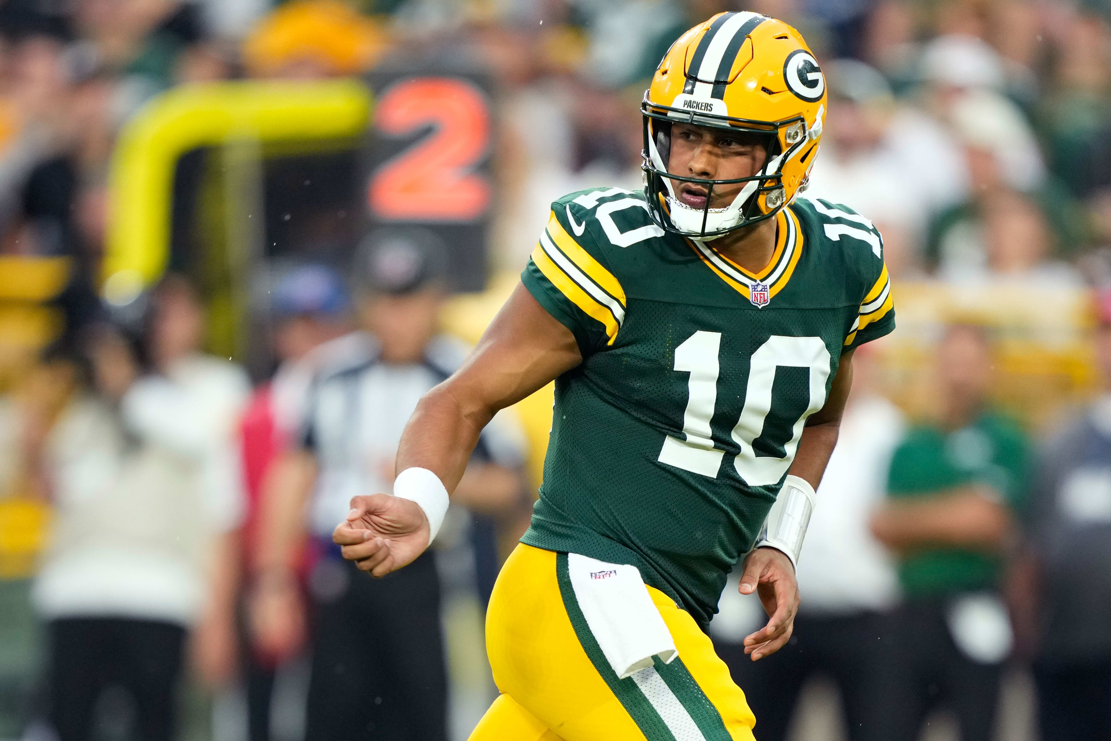 Aug 9, 2025; Green Bay, Wisconsin, USA;  Green Bay Packers quarterback Jordan Love (10) watches the ball after handing it off during the first quarter against the New York Jets at Lambeau Field.