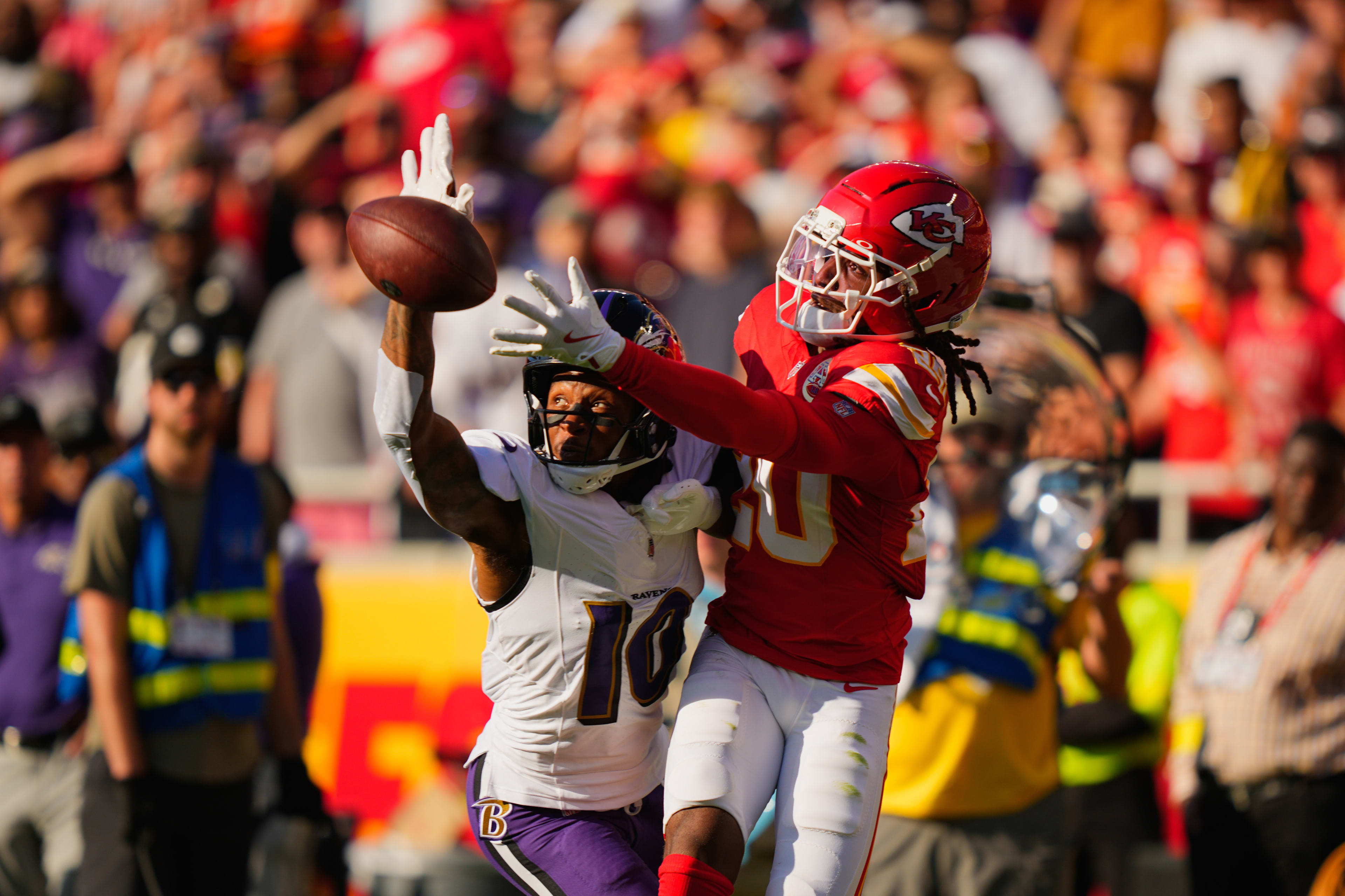 Sep 28, 2025; Kansas City, Missouri, USA; Kansas City Chiefs cornerback Nohl Williams (20) breaks up a pass intended for Baltimore Ravens wide receiver DeAndre Hopkins (10) during the first half at GEHA Field at Arrowhead Stadium. 
