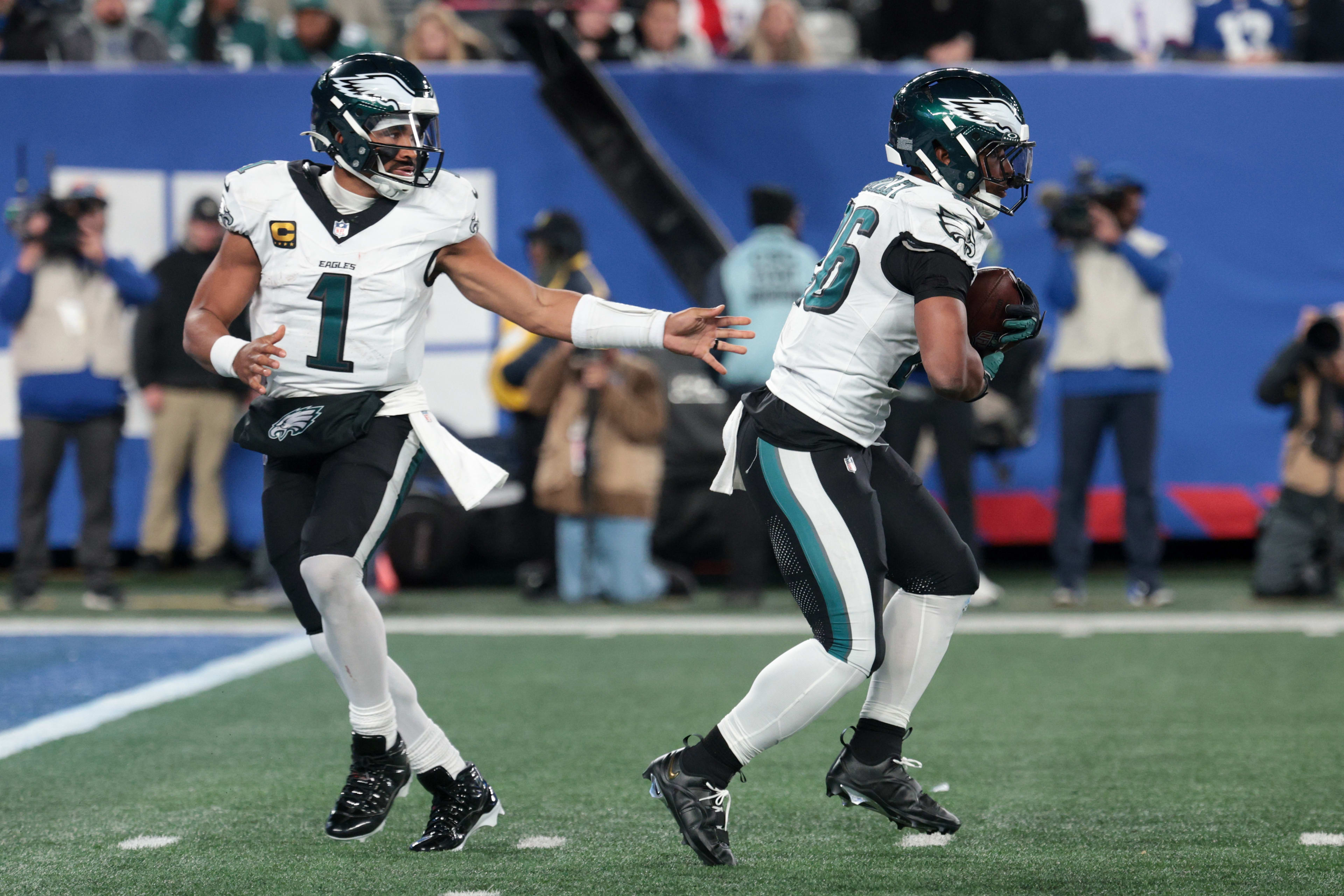 Oct 9, 2025; East Rutherford, New Jersey, USA; Philadelphia Eagles quarterback Jalen Hurts (1) hands off the ball to running back Saquon Barkley (26) during the third quarter of the game at MetLife Stadium. Mandatory Credit: Vincent Carchietta-Imagn Images