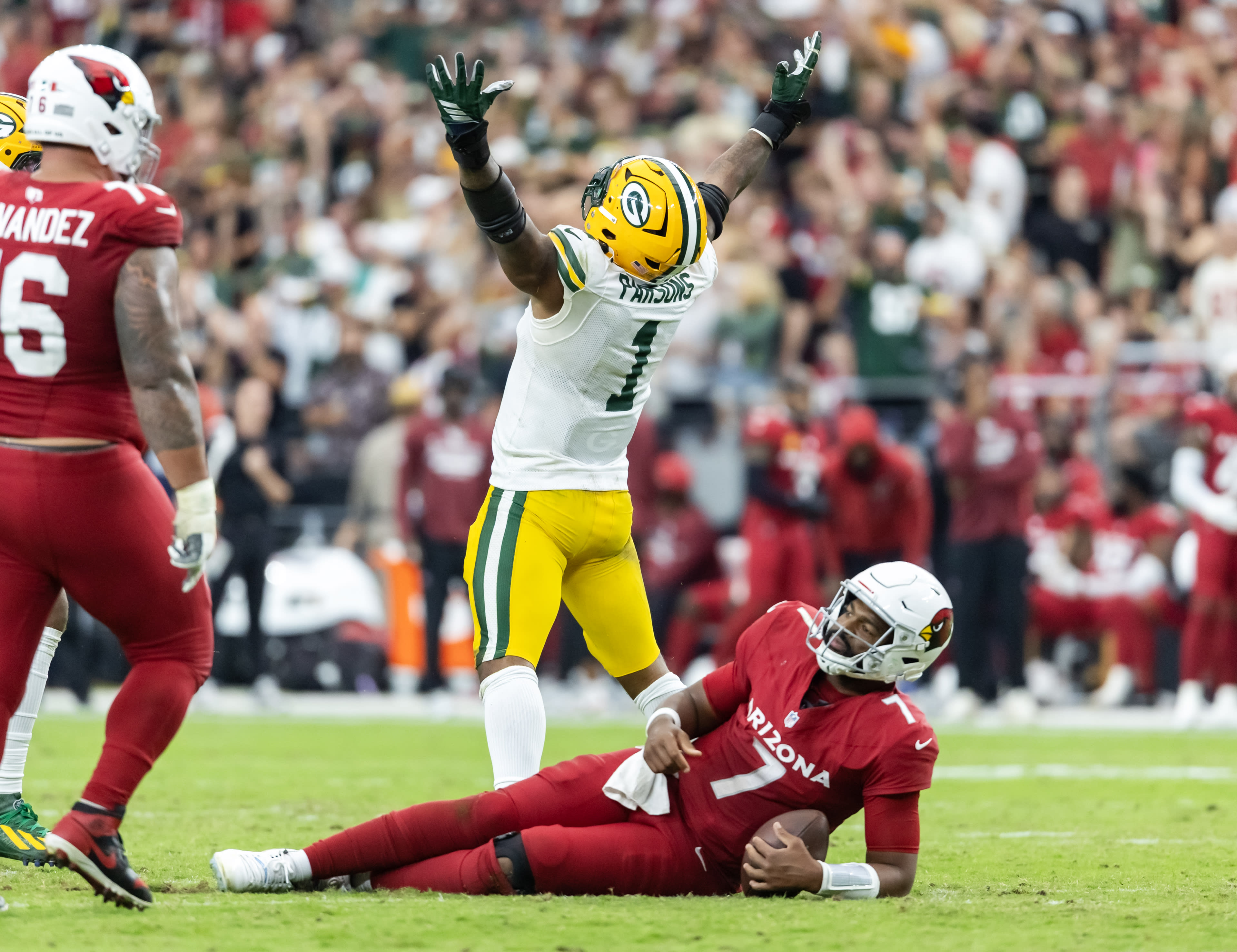 Oct 19, 2025; Glendale, Arizona, USA; Arizona Cardinals quarterback Jacoby Brissett (7) is sacked by Green Bay Packers defensive lineman Micah Parsons (1) in the second half at State Farm Stadium.