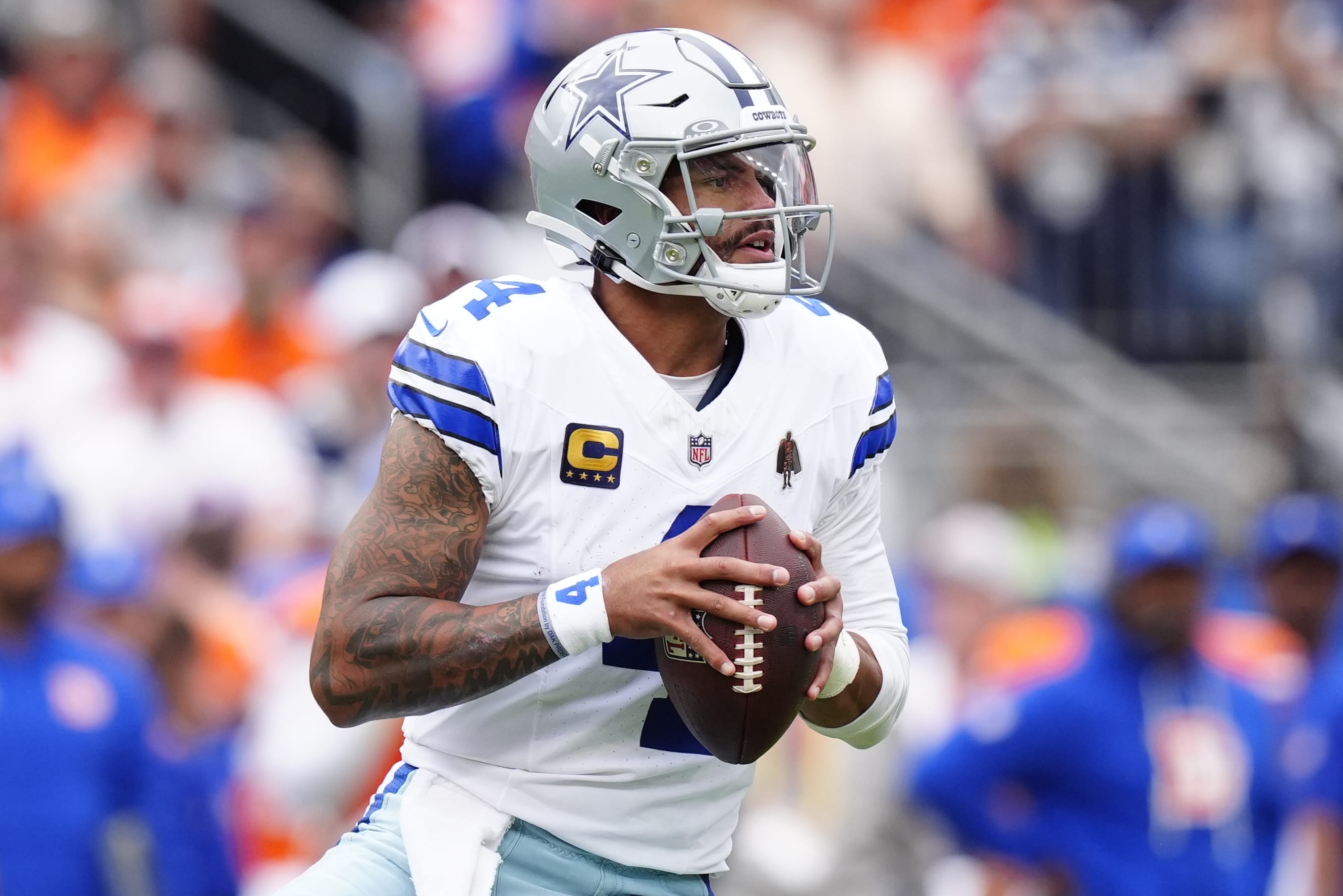 Oct 26, 2025; Denver, Colorado, USA; Dallas Cowboys quarterback Dak Prescott (4) looks to throw against the Denver Broncos in the first half at Empower Field at Mile High. Mandatory Credit: Ron Chenoy-Imagn Images
