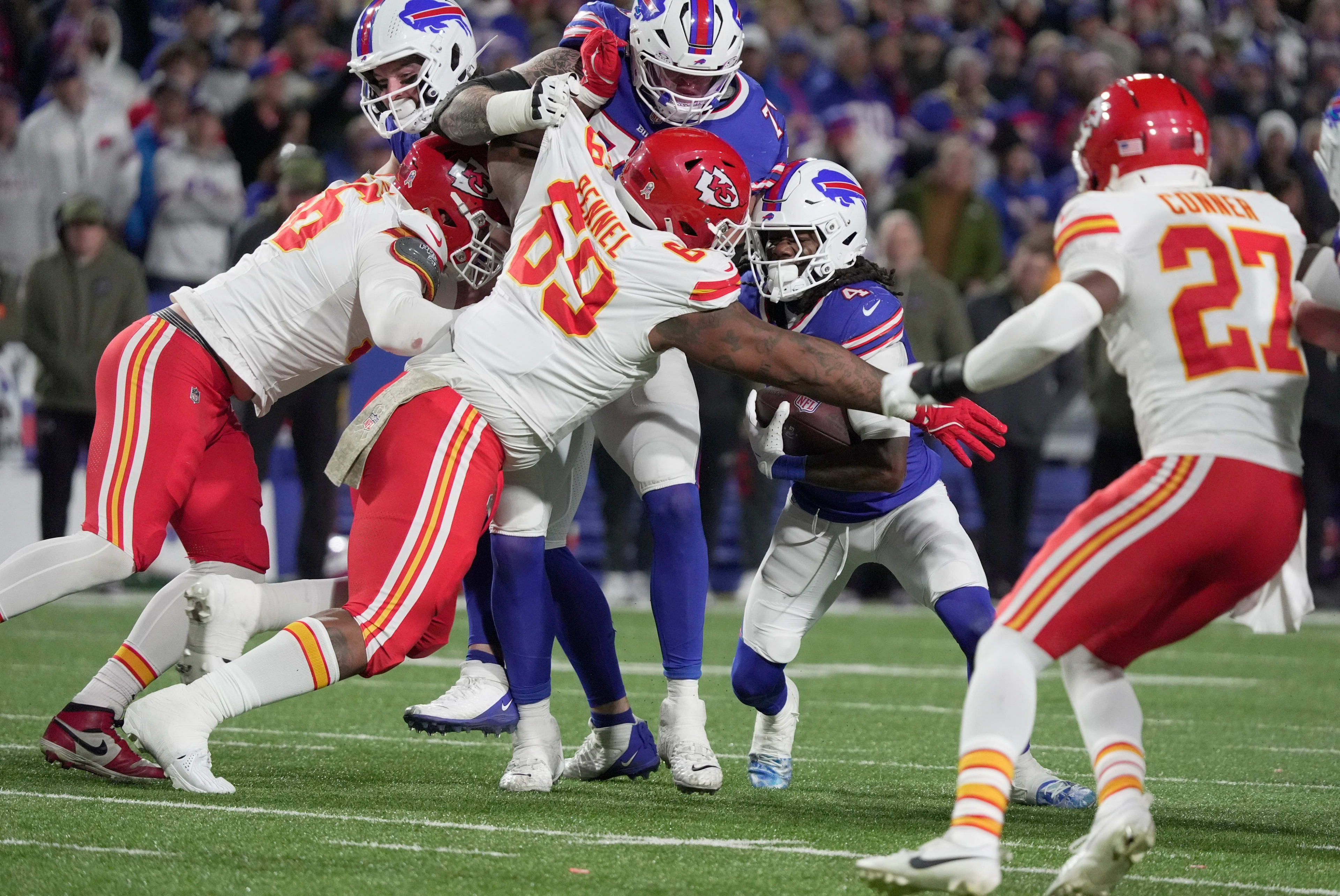 Buffalo Bills running back James Cook III uses teammate offensive tackle Spencer Brown as a shield as he unsuccessfully tries to get by Kansas City Chiefs defensive tackle Mike Pennel during second half action against the Kansas City Chief at Highmark Stadium in Orchard Park on Nov. 2, 2025.
