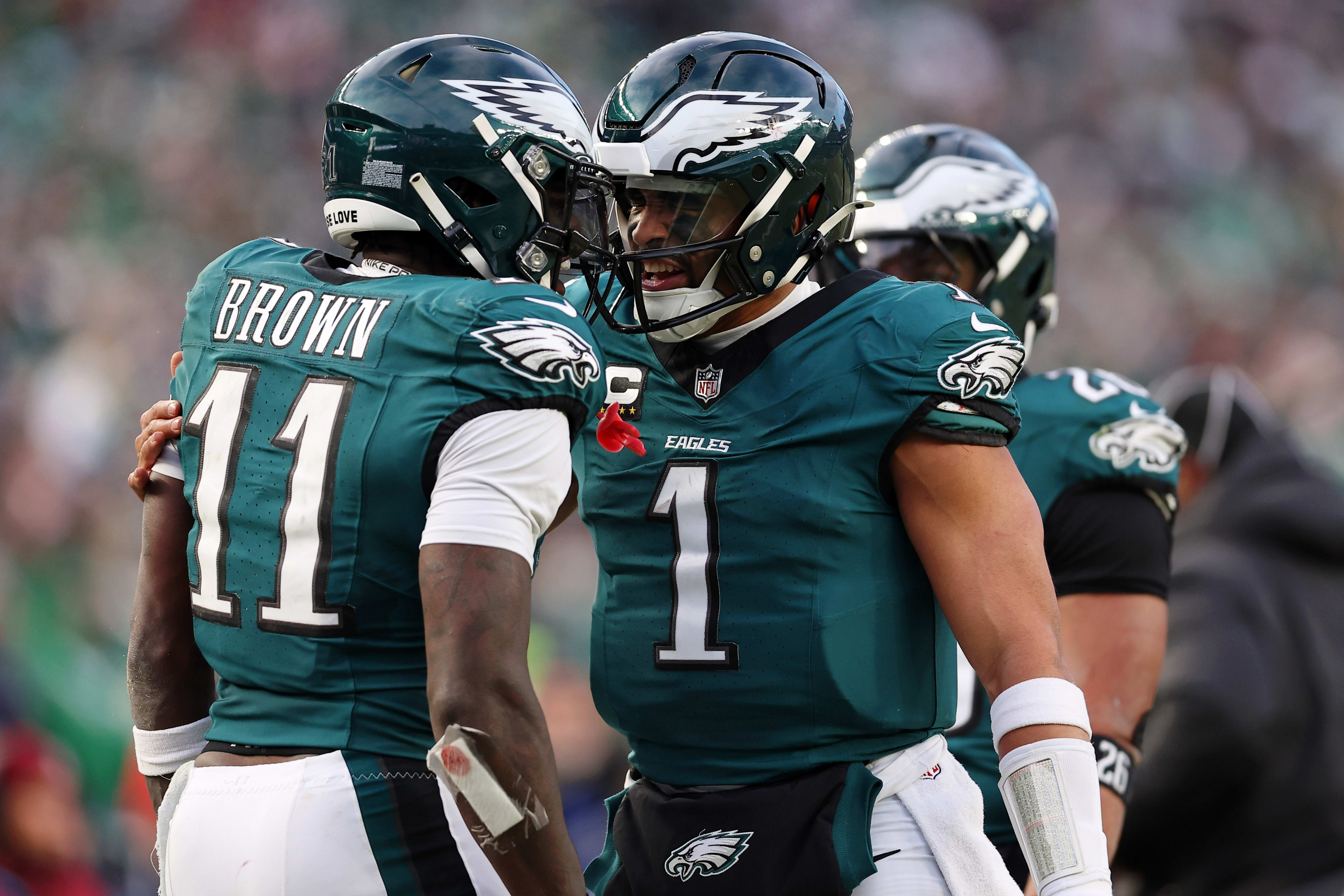 Jan 26, 2025; Philadelphia, PA, USA; Philadelphia Eagles quarterback Jalen Hurts (1) and wide receiver A.J. Brown (11) celebrate after a touchdown against the Washington Commanders during the first half in the NFC Championship game at Lincoln Financial Field. Mandatory Credit: Bill Streicher-Imagn Images