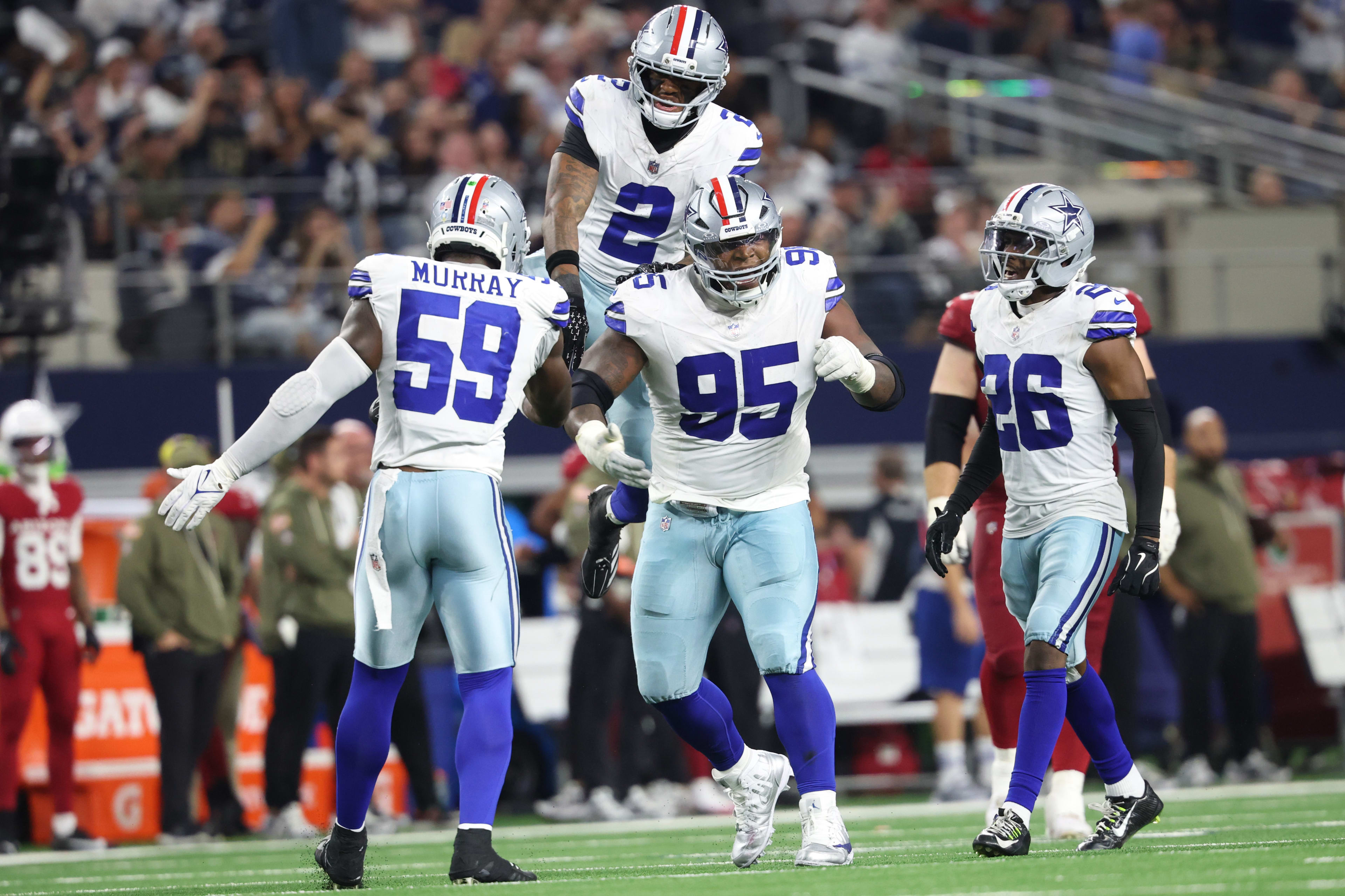 Nov 3, 2025; Arlington, Texas, USA; Dallas Cowboys defensive tackle Kenny Clark (95) celebrates with safety Juanyeh Thomas (2) and linebacker Kenneth Murray Jr. (59) and cornerback DaRon Bland (26) in the second half against the Arizona Cardinals at AT&T Stadium. 
